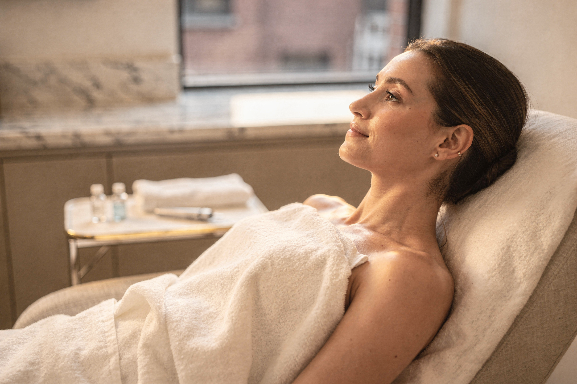 Patient reclined in treatment chair during microneedling consultation at Natural Beauty Fifth Avenue